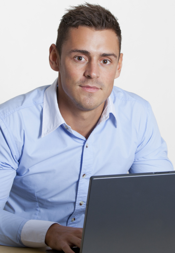 Man at computer looking directly into camera