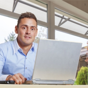 Young man at work on a laptop computer