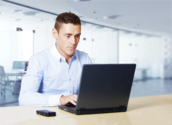 handsome young man working on a laptop computer