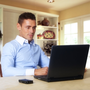 Man working at laptop computer from home