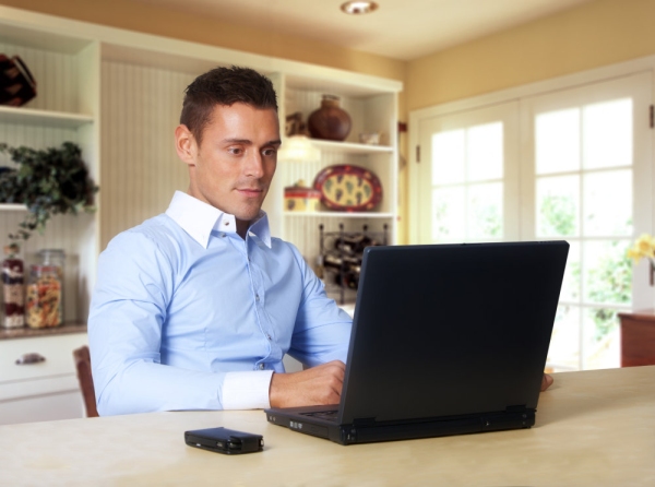 Man working at laptop computer from home