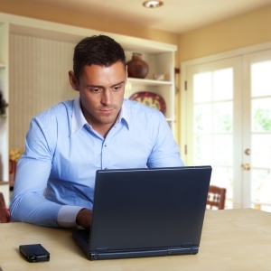 Man working at laptop computer from home