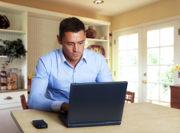 Man working at laptop computer from home