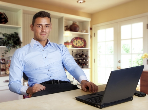 Man working at laptop computer from home