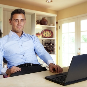 Man working at laptop computer from home