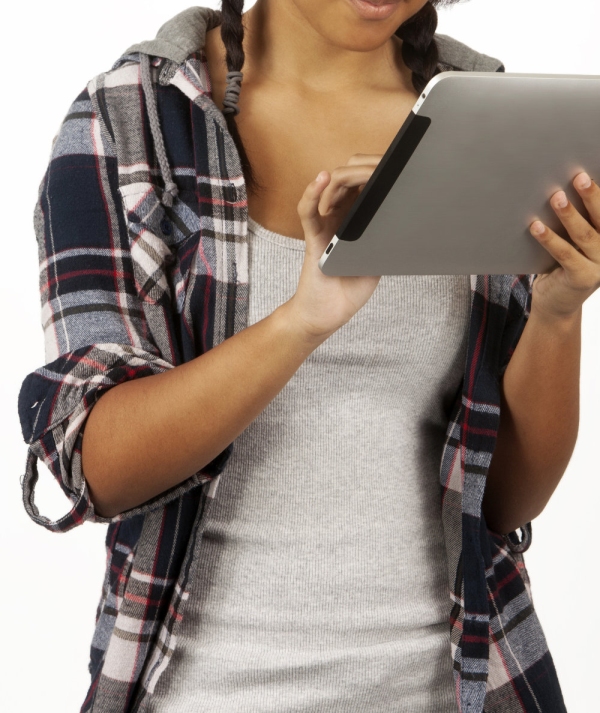 a mixed race teenage girl working on an iPad with white background