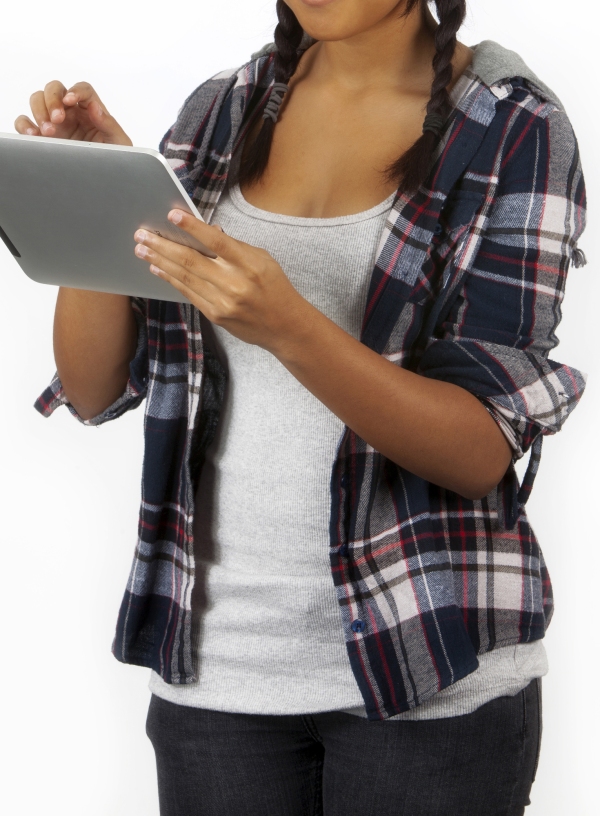 a mixed race teenage girl working on an iPad. White background