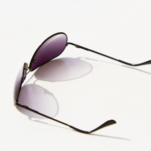 Aviator style sunglasses on a white table top