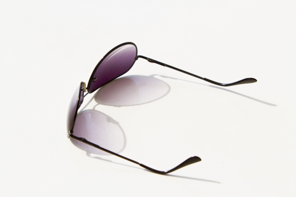 Aviator style sunglasses on a white table top