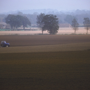 Tilling a field in the autumn in a suffolk river valley