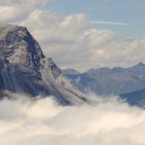 View of beautiful landscape in the Alps - Clouds rolling past the mountains