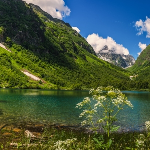 A pristine mountain lake surrounded by snow capped mountains