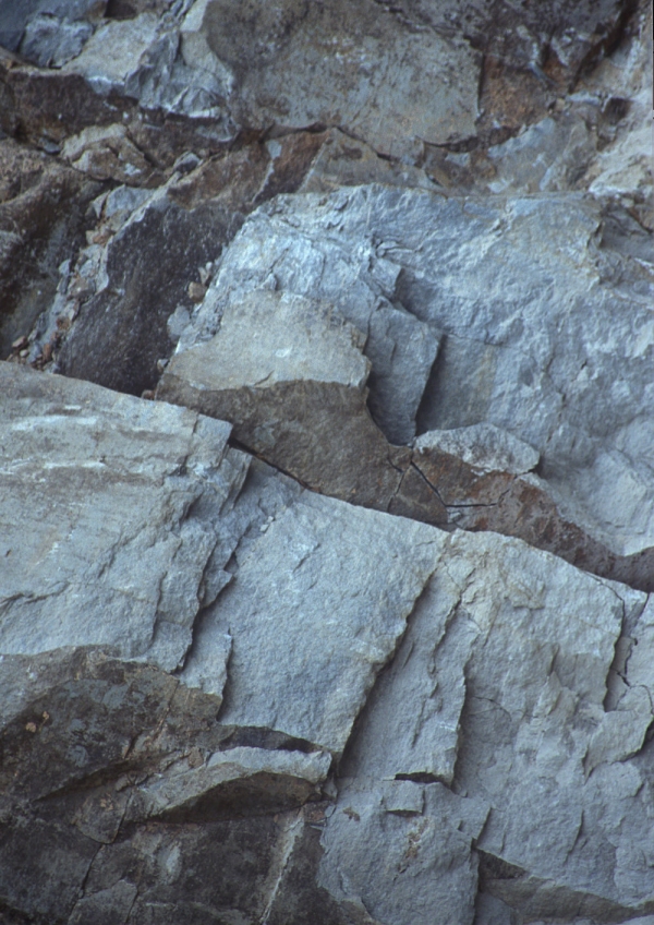 A close up view of rock face with gigantic fissures