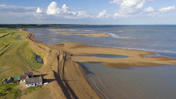 Aerial view of the suffolk coastline at Shingle Street looking towards Orford in the late afternoon