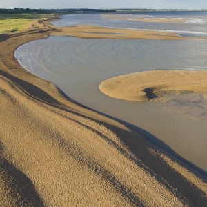 Aerial view of the shingle banks and islands at low tide at the mouth of the river alde on the suffolk coast