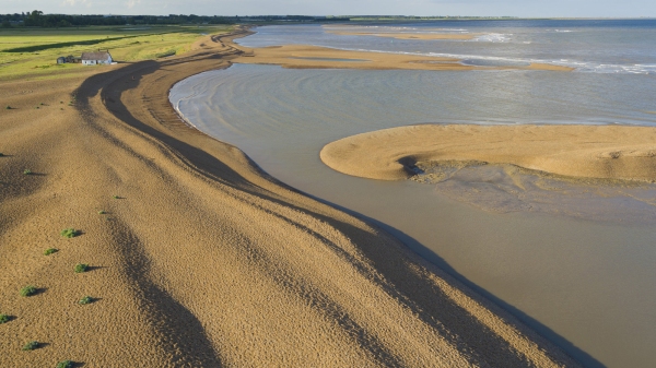 Aerial view of the shingle banks and islands at low tide at the mouth of the river alde on the suffolk coast