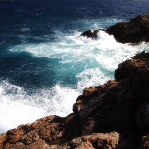 White breakers and surf pounding a rocky mediterranean coast