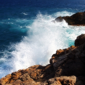 White waves and breakers pounding the rocks on a mediterranean coast