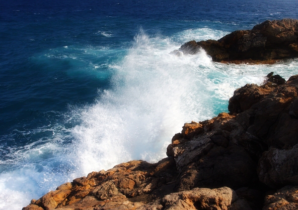 White waves and breakers pounding the rocks on a mediterranean coast