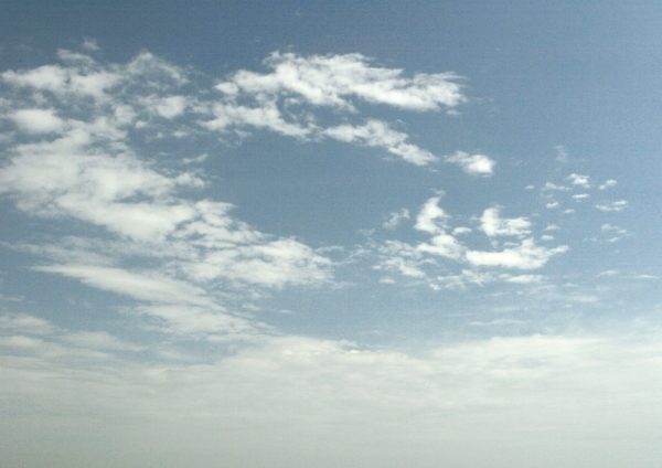 Wispy white clouds in an evening sky