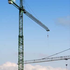 Construction cranes against a blue sky