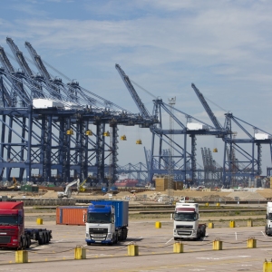 Trucks, lorries and cranes at large container port