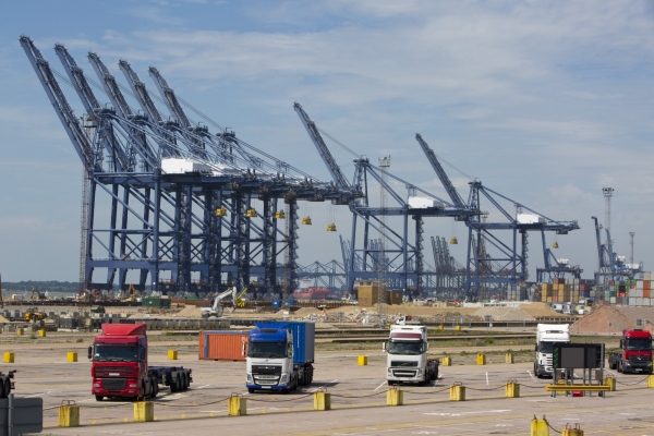 Trucks, lorries and cranes at large container port