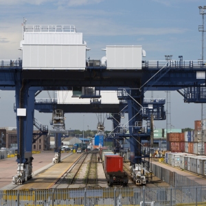 A vast crane on rails for shifting containers and loading trucks and railway carriages