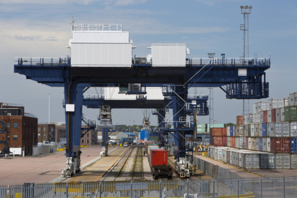 A vast crane on rails for shifting containers and loading trucks and railway carriages