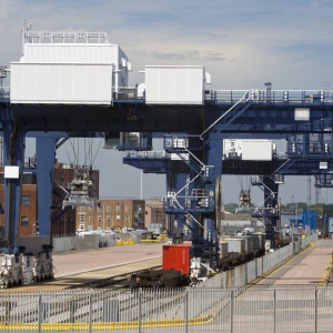 A vast crane on rails for shifting containers and loading trucks and railway carriages