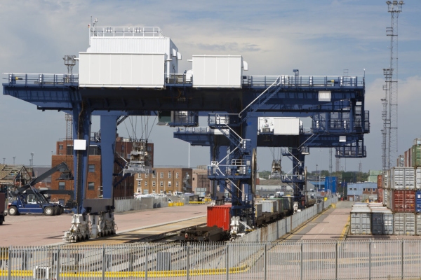 A vast crane on rails for shifting containers and loading trucks and railway carriages