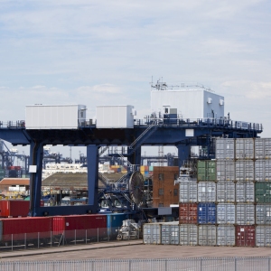 A vast crane on rails for shifting containers and loading trucks and railway carriages