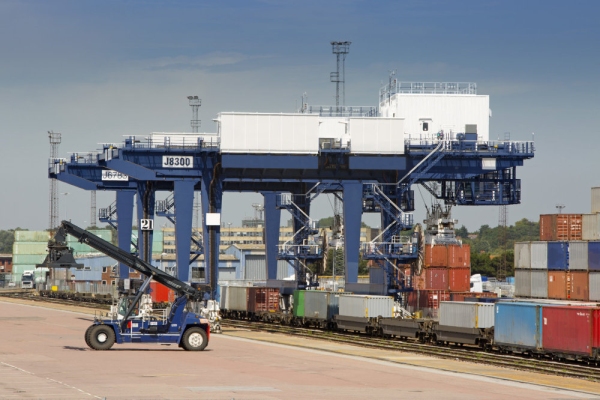 A vast crane on rails for shifting containers and loading trucks and railway carriages