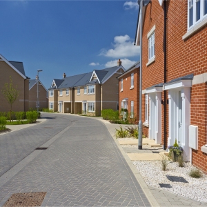 An empty street in a mostly complete new housing development