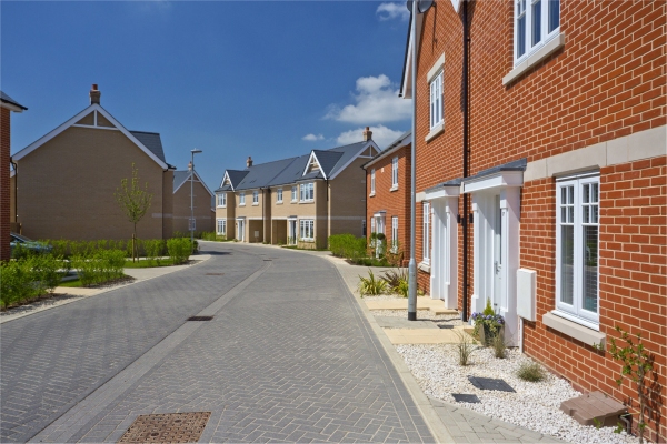 An empty street in a mostly complete new housing development