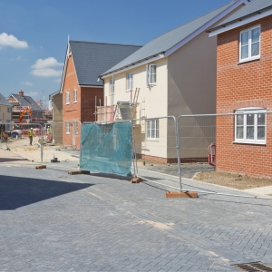 A building site on a large new greenfield housing development with breeze blocks, half built walls, bricks and scaffolding