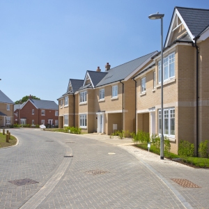 An empty street in a mostly complete new housing development