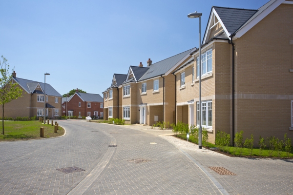 An empty street in a mostly complete new housing development