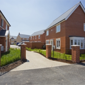 An empty street in a mostly complete new housing development