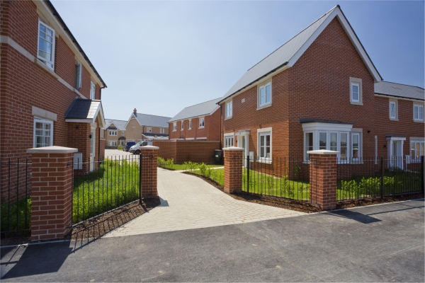 An empty street in a mostly complete new housing development