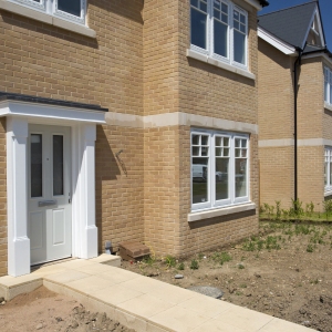 A new house in a greenfield housing development that has been sold before completion