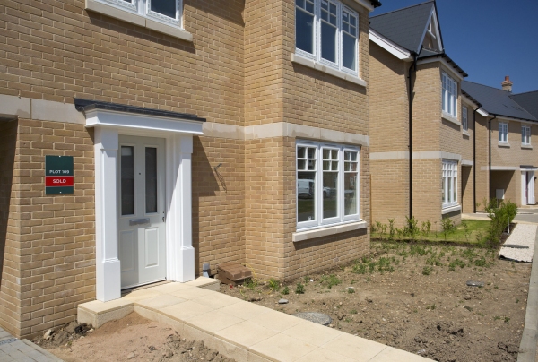 A new house in a greenfield housing development that has been sold before completion