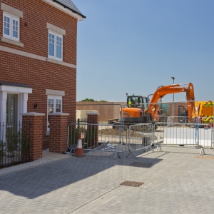 A new house in a greenfield housing development with construction work continuing alongside