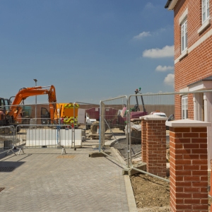 A new house in a greenfield housing development with construction work continuing alongside