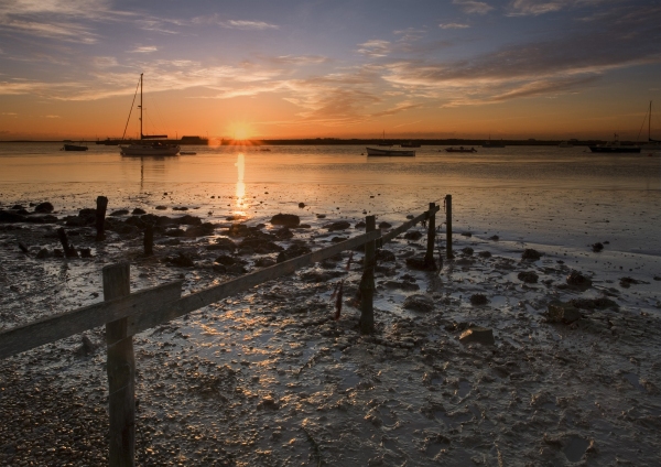 A brigh orange sunset over the estuary at Orford