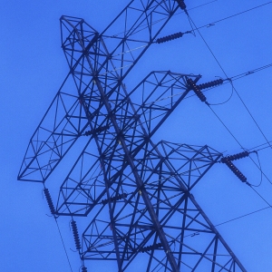 An electricity pylon against a very blue sky