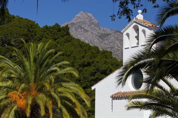 A spanish church in Andalusia with the Sierra de las Nieves in the distant background