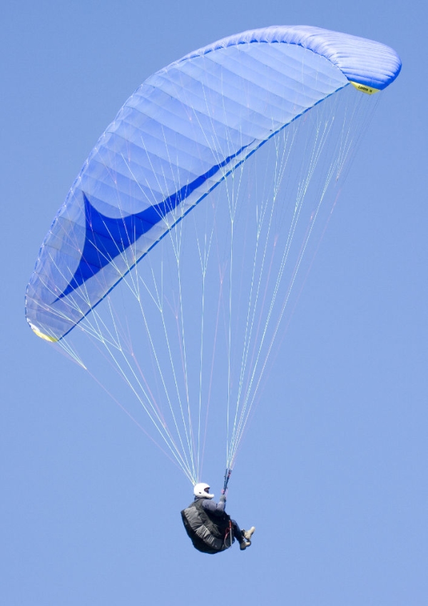 Paragliding on a hot summer's day against a perfect blue sky