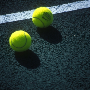 Tennis balls on a hard court