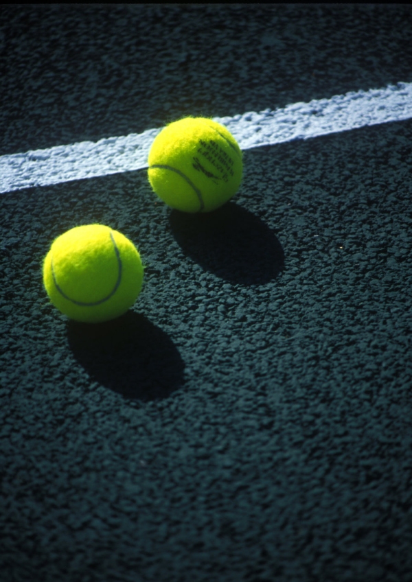 Tennis balls on a hard court